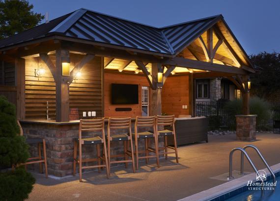 Night Shot of 14' x 27' Custom Timber Frame Pool House with Bar, Lounge, & Storage