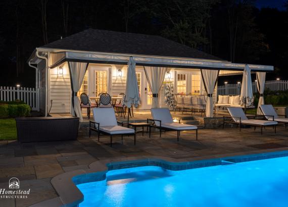 Nighttime shot of 16' x 30' Luxury Hip Roof Pool House in Greenwich, Connecticut