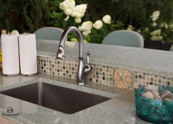 Sink in custom outdoor kitchen pavilion