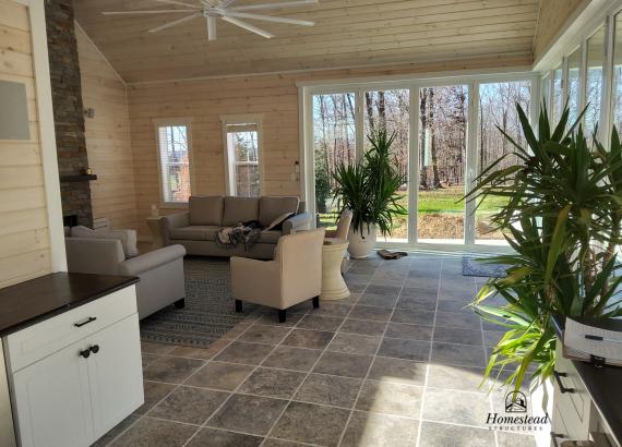 Finished interior Lounge & Fireplace of 30' x 32' Custom Pool House with Origin Bi-Fold Doors 