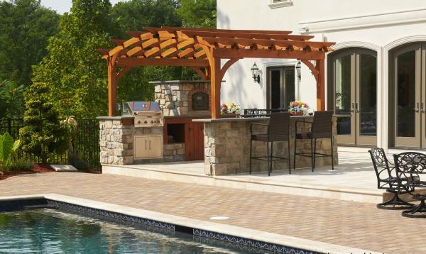 10 x 14 arch wood pergola by Homestead Structures over outdoor kitchen