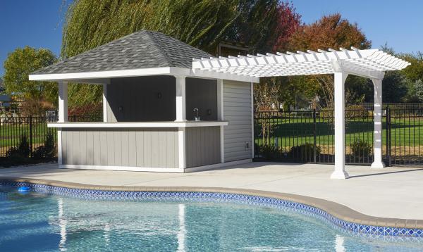 Attached white vinyl pergola by Homestead Structures next to pool