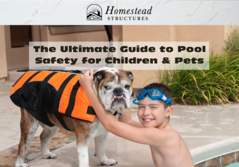 A child with goggles on in a swimming pool hugs their pet bulldog. The bulldog is wearing a lifejacket and standing at the pool’s edge. 