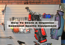 Balls, a bicycle, and other various sporting equipment stored neatly inside a garage.