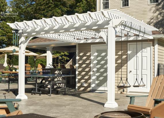 View of 12'x12' Vinyl Pergola with swings attached to Siesta Pool House