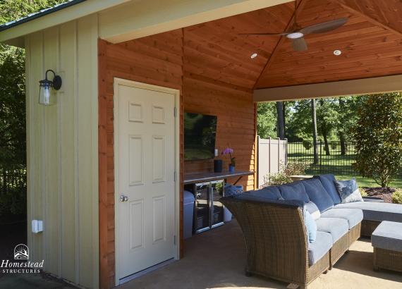 Under the pavilion of a 14' x 18' Avalon Pool House with blue metal roof in Center Valley, PA