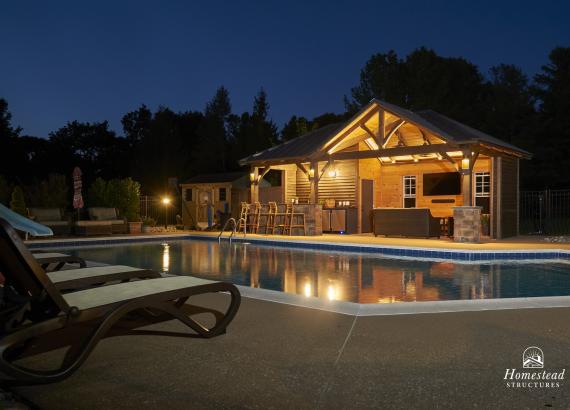 Night Shot of 14' x 27' Custom Timber Frame Pool House with Bar, Lounge, & Storage