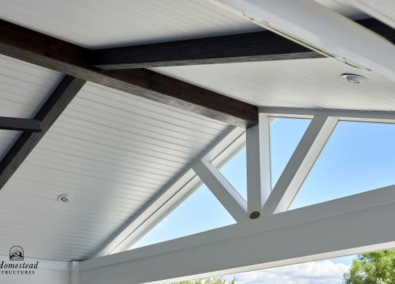 Photo os white vinyl beaded ceiling with dark etchwood beams on 18x17 attached pavilion in Royersford, PA