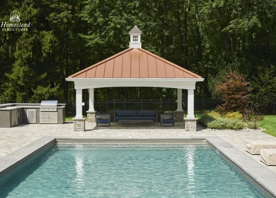 View from across the pool of an18'x18' Vintage Pavilion with metal roof in Basking Ridge New Jersey