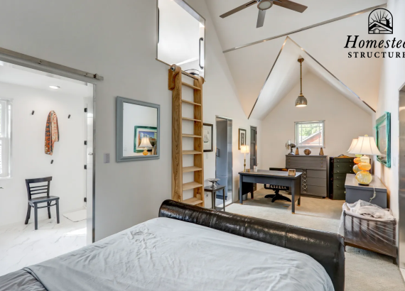 Alternate angle of a ladder leading to additional space, showcasing the doors to a bathroom and office area in a custom-designed two-story garage