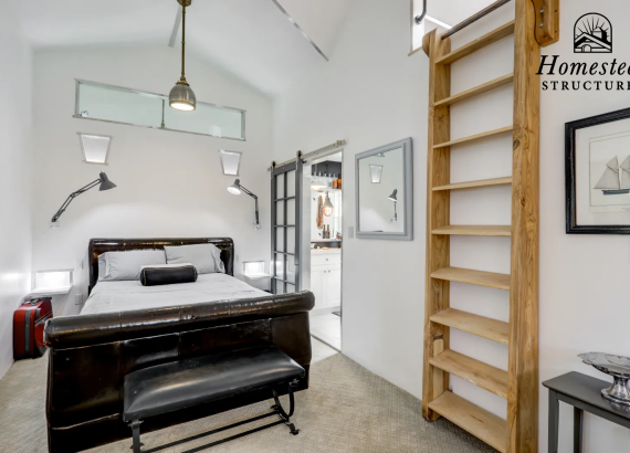 Living room featuring a bed and a ladder leading to additional space, designed for comfort and efficient use of a garage's second level