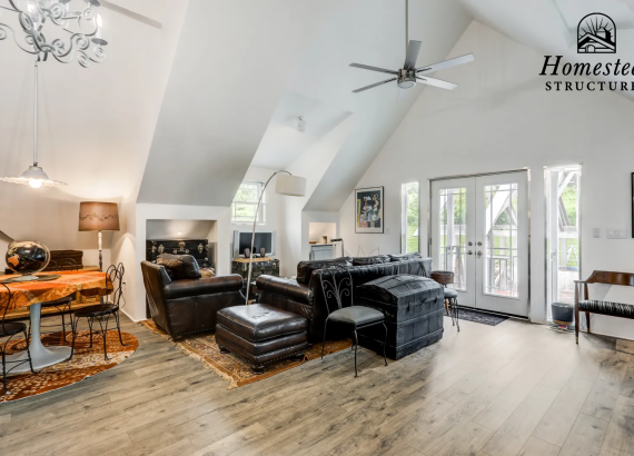 Comfortable living area on the second level of a custom-designed garage, featuring modern furnishings and functional design