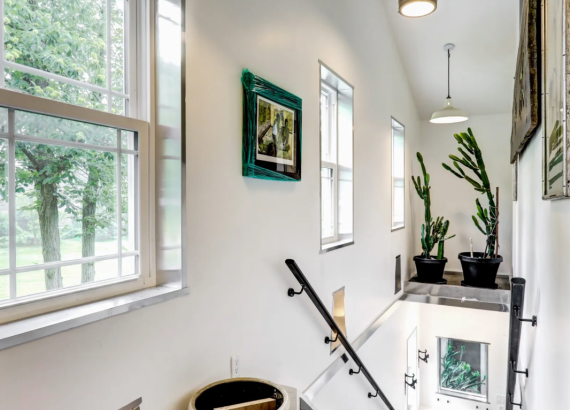 Spacious hallway leading to the second-level living area of a custom-designed garage, showcasing elegant finishes and craftsmanship