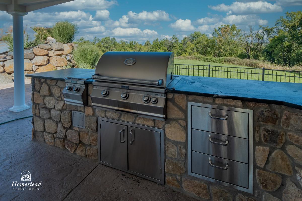 Custom outdoor kitchen with grill cooktop.